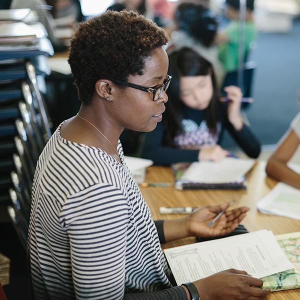 Teacher speaking with students